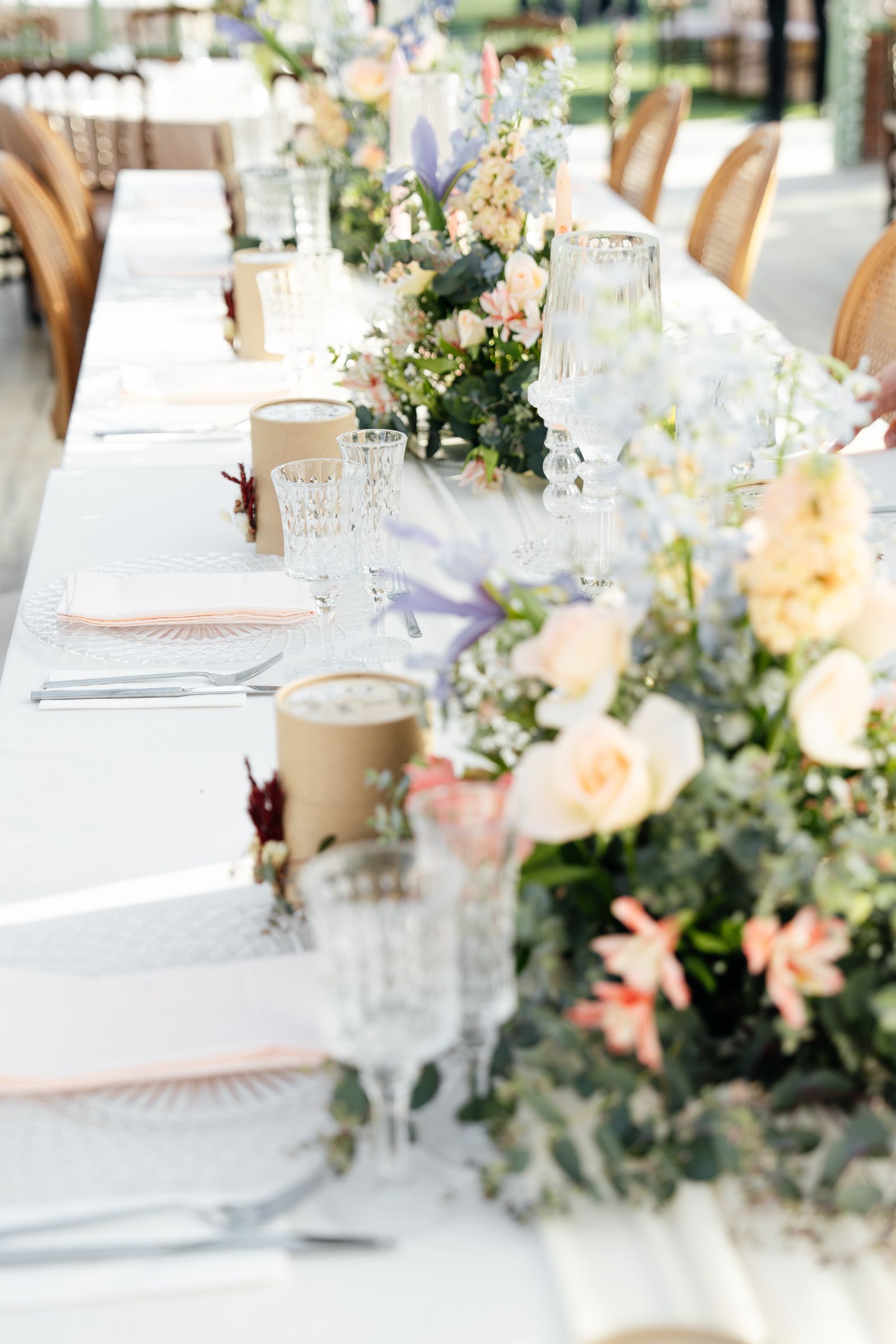 Floral wedding tablescape with glassware and elegant place settings